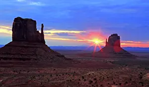 Iconic Prints: Sunrise over rock formations in Monument Valley