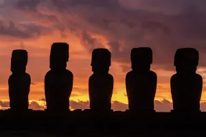 Mystery Prints: Sunrise silhouettes of moai at Ahu Tongariki on Easter Island in Chile with orange and purple sky