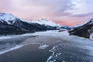 Engadine Prints: Sunrise on the snowcapped mountains and frozen Lake Silvaplana, aerial view, Maloja