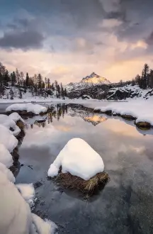 Sondrio Prints: Sunrise above snowy peak of Sasso Moro mirrored in lake MufulA¨, Malenco Valley