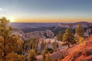 Hoodoos Prints: Sunrise at Sunrise Point in Bryce Canyon National Park revealing rock formations and trees in Utah