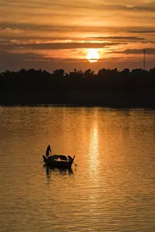 Unrecognisable Person Prints: Sunrise on the Tonle Sap River near the village of Kampong Tralach