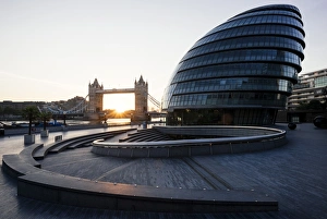 Sunrise behind Tower Bridge and The Mayors Building (City Hall), London, England