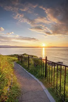 Hokkaido Prints: Sunrise view from Cape Tachimachi overlooking the calm waters and grassy paths in Hakodate