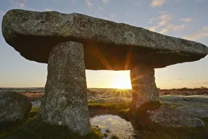 Sunbeam Prints: A sunrise view of the remains of a prehistoric burial chamber, known as Lanyon Quoit