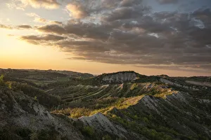 Sunset above badlands and countryside with colored clouds in the sky, Bologna, Emilia Romagna, Italy, Europe Sunset above badlands and countryside with colored clouds in the sky, Bologna, Emilia Romagna, Italy, Europe