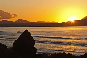 Canaries Prints: Sunset over the bay at Famara, Lanzarotes finest surf beach in the north west of the island