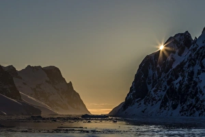 Booth Island Prints: Sunset over Booth Island in the waters of the Lemaire Channel, Antarctica, Polar Regions