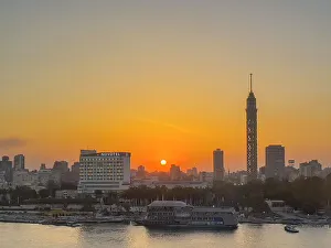 High Rises Prints: Sunset over the Cairo Tower from the east side of the Nile River