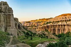 Cappadocia Prints: Sunset casts light on Pigeon Valley rock formations in Cappadocia Turkey showcasing the unique landscape of the region