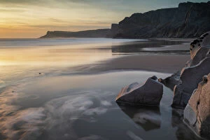 Dramatic Landscape Gallery: Sunset over a deserted Mewslade Bay in Gower in winter, South Wales, United Kingdom