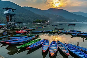 Sunset over Fewa Lake with many rowing boats, Pokhara, Nepal, Asia