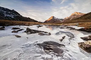 Alpine Scene Prints: Sunset frames the alpine creek covered with ice at Bernina Pass, Canton of Graubunden