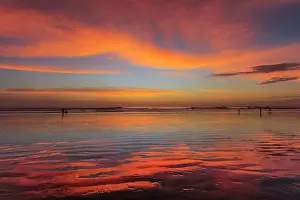 Back Lit Prints: Sunset at Guiones Beach where hundreds of people gather to watch in high season