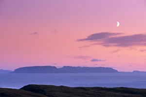 Sunset and half moon over Eigg island
