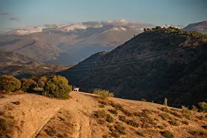 Granada Prints: Sunset over the hills behind Granada and wide landscapes with the snowy Sierra Nevada behind