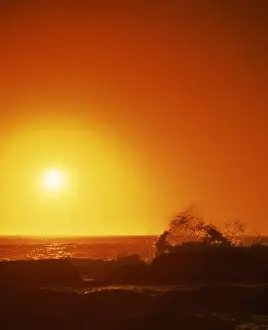Seascapes Prints: Sunset over the Indian Ocean, with waves breaking on coastline of Prevwlly
