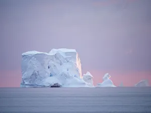 Sunset on a large iceberg at sea towards Peter I Island, Bellingshausen Sea, Antarctica, Polar Regions