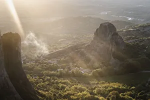 Meteora Prints: Sunset light and sun beams in the smoke in Meteora, Thessaly, Greece, Europe