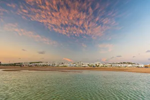Sunset above the ocean and coastal town of Conil de la Frontera, Costa de la Luz