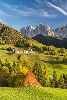 Sunset over the Odle Group and village of Santa Magdalena in autumn, Funes Valley