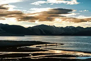 2 People Prints: Sunset at Pan Gong lake with golden light reflection in the flat waters showing two people walking along the shore