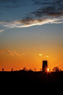 Rural Scenes Gallery: Sunset behind the Parish Church of the Holy Trinity and All Saints at Winterton on Sea