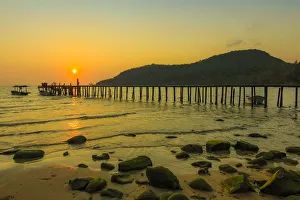 Traditionally Cambodian Prints: Sunset and pier on the quiet rocky west coast of this holiday island, Lazy Beach
