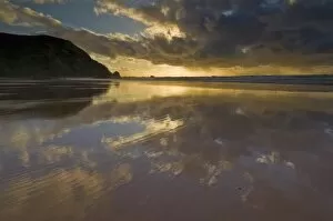 Sunset reflected in tidal wash, Praia do Castelejo beach near Vila do Bispo