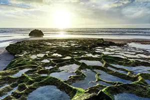 Hour Prints: Sunset over seaweed and rock formations on Cofete beach
