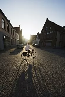 Images Dated 5th July 2010: Sunset and shadow of a cyclist on cobbled street, old town, UNESCO World Heritage Site