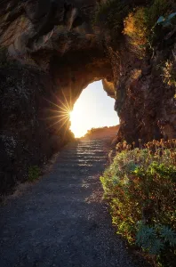 Stairs Prints: Sunset shining through a rock tunnel near Ponta do Sol in Madeira region of Portugal
