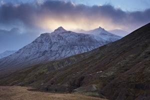 Sunset on snowy mountains, Skumhottur, 1229m, in Reydarfjordur fjord, East Fjords