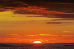 Nicoya Peninsula Prints: Sunset & sunlit clouds over Playa Guiones surf beach