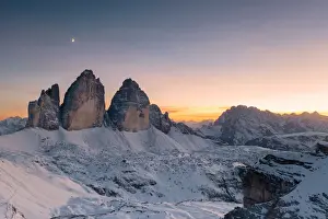 Sunset over Tre Cime di Lavaredo and Monte Cristallo covered with snow in autumn