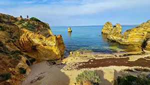 Hour Prints: Sunset view of beach cliffs in Algarve showing rock formations and clear waters near Lagos