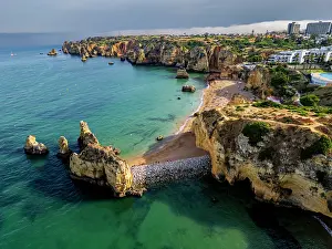 Enjoyment Prints: Sunset view of beach cliffs with calm waters and sandy shores in Algarve region of Portugal