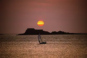 Nautical Prints: Sunset view over the British Channel from Saint Malo with a sailing boat and islands in silhouette