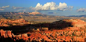 Dirt Prints: Sunset view of Bryce Canyon showing rock formations and distant mountains in Utah