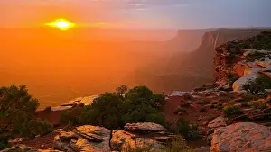 Canyonlands Prints: Sunset view over the canyons creating orange hues at Grand View Point in Canyonlands National Park during evening hours