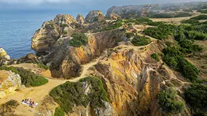 Trail Prints: Sunset view of cliffs and beach in Lagos along the Algarve coast in Portugal