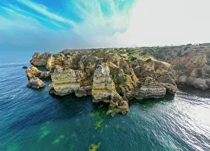 Seascape Prints: Sunset view of cliffs with ocean surrounding them near Lagos in Algarve region of Portugal