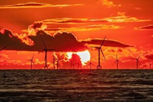 : Sunset view towards the distant Walney Offshore wind farm from Walney Island on the Cumbrian