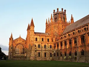 Cambridgeshire Prints: Sunset view of Ely Cathedral in Ely Cambridgeshire with changing light on the stone facade