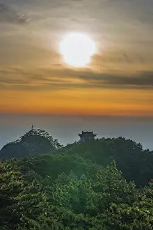 Visual Prints: Sunset view at Huangshan Mountain with natural light and distant structures in Anhui province