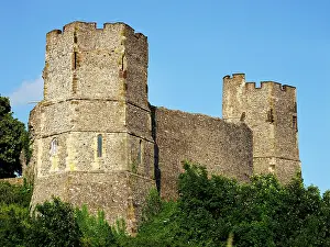 Sunset view of Lewes Castle in East Sussex with clear skies and green surroundings, highlighting stone structure and towers
