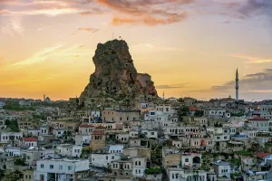 Cappadocia Prints: Sunset view of Ortahisar city with its castle and mosque set against the evening sky in Cappadocia