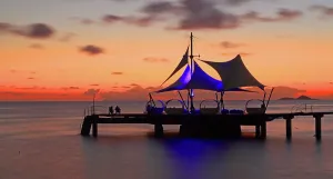 Silhouettes Prints: Sunset view from pier at Coco de Mer resort on Praslin Island with silhouettes of people against the sky