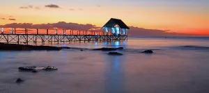 Mauritius Prints: Sunset view over a pier with lights at Pointe aux Piments in Mauritius