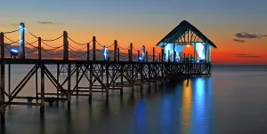 Atmosphere Prints: Sunset view over a pier with lights shining